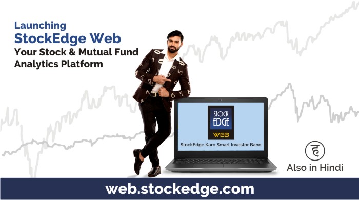 This is a digital image of a man in a suit standing next to a laptop with the words “stockedge web” on the screen.