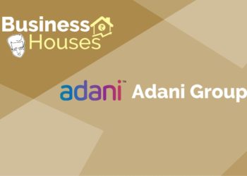 A logo for the adani group, an indian multinational conglomerate headquartered in ahmedabad, gujarat, india. The logo includes the stylized name “adani” in blue letters, with a curved orange line underneath.