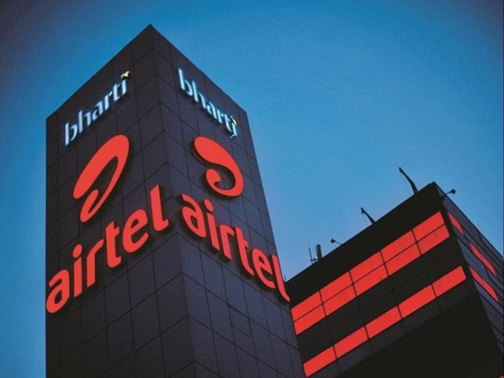 A photo of the airtel building at night with the company’s logo and name in red lights