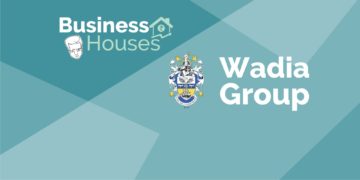 A graphic image with a blue and green background with the text ‘business houses’ and ‘wadia group’ and a coat of arms in the center.