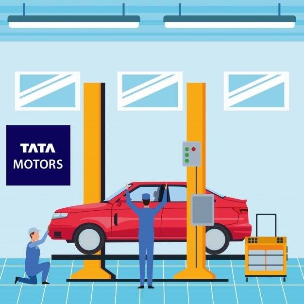 A red car on a lift in a tata motors garage with two mechanics working on it.