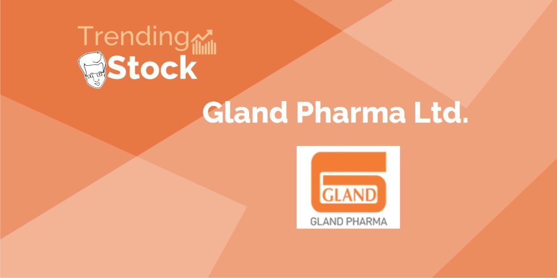 A graphic representation of a trending stock. It has an orange background with darker orange geometric shapes creating a pattern. In the upper left corner, there is an icon of a face, next to which are the words “trending stock” and an upward graph indicating positive performance. The central part of the image prominently displays “gland pharma ltd.