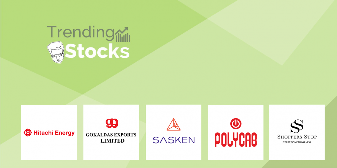A graphic displaying “trending stocks” with logos of hitachi energy, gokaldas exports limited, sasken, polycab, and shoppers stop on a green background. The image has a light green background with a darker green geometric pattern