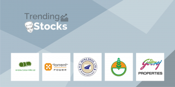 A group of company logos displayed on a gray background with the text "trending stocks" above them. Logos include engg, godrej properties, we make people move, torrent power, and ambika cotton mills ltd.